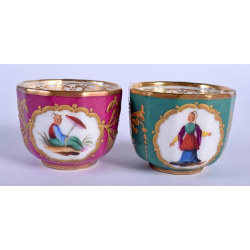 99 - AN UNUSUAL PAIR OF 19TH CENTURY CONTINENTAL PORCELAIN CUPS AND SAUCERS painted with Chinese figures.... 