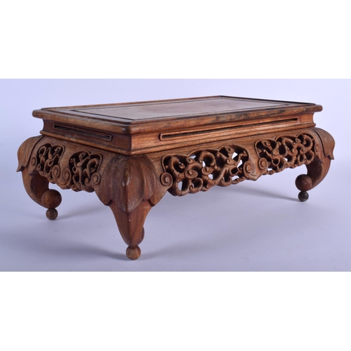 1515 - A 19TH CENTURY CHINESE CARVED HARDWOOD RECTANGULAR STAND Qing, possibly Huanghuali, decorated with l... 