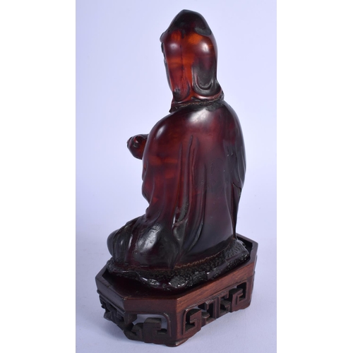 1519 - AN EARLY 20TH CENTURY CHINESE CARVED AMBER TYPE FIGURE OF GUANYIN late Qing/Republic, upon a fitted ... 