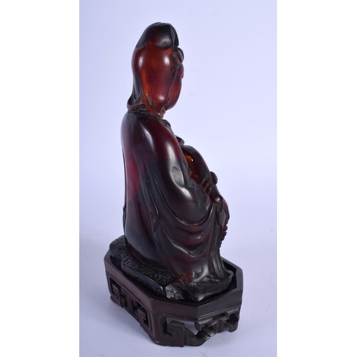 1519 - AN EARLY 20TH CENTURY CHINESE CARVED AMBER TYPE FIGURE OF GUANYIN late Qing/Republic, upon a fitted ... 