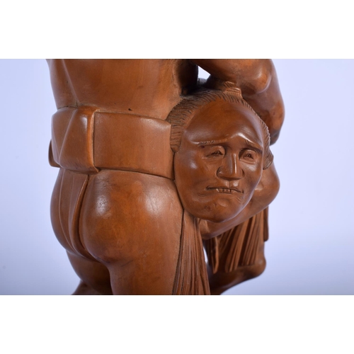1520 - AN EARLY 20TH CENTURY JAPANESE MEIJI PERIOD CARVED BOXWOOD FIGURE OF SUMO WRESTLERS upon a textured ... 