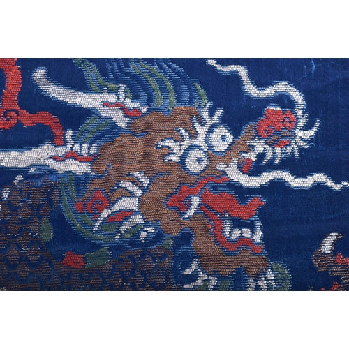 1525 - A 17TH/18TH CENTURY CHINESE BLUE SILK BROCADE EMBROIDERED PANEL Ming/Qing, decorated with dragons. 4... 