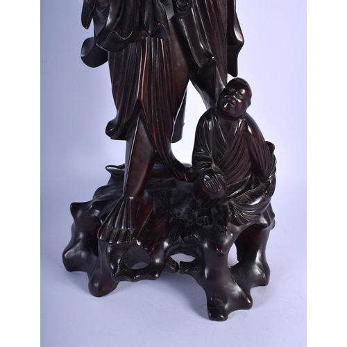 1542 - A VERY LARGE 19TH CENTURY CHINESE CARVED HARDWOOD FIGURE OF A FISHERMAN Qing, modelled holding a fis... 