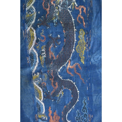 1544 - A RARE PAIR OF 17TH/18TH CENTURY CHINESE BLUE SILK WORK DRAGON PANEL Ming/Qing, modelled amongst clo... 