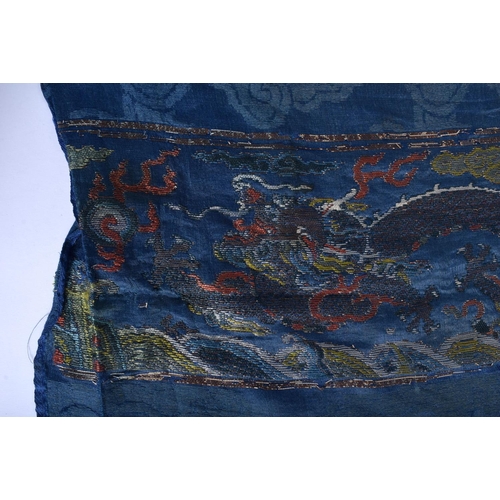 1544 - A RARE PAIR OF 17TH/18TH CENTURY CHINESE BLUE SILK WORK DRAGON PANEL Ming/Qing, modelled amongst clo... 