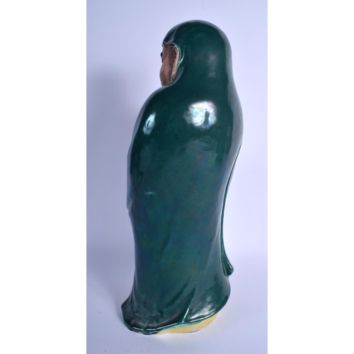 1546 - A LARGE 19TH CENTURY JAPANESE MEIJI PERIOD GREEN GLAZED STONEWARE FIGURE modelled holding a swish. 4... 