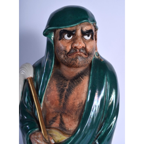 1546 - A LARGE 19TH CENTURY JAPANESE MEIJI PERIOD GREEN GLAZED STONEWARE FIGURE modelled holding a swish. 4... 