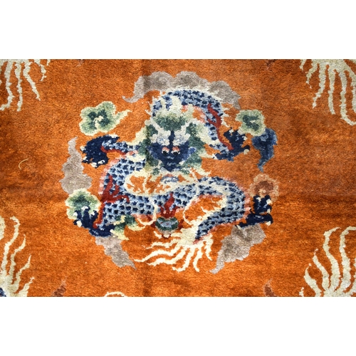 1593 - AN EARLY 20TH CENTURY CHINESE SILK WORK DRAGON PILLAR CARPET decorated upon a orange ground. 192 cm ... 