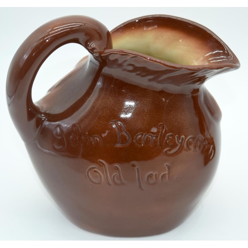 2527 - A  figure of a horse on a stand together with a Character jug of John Barleycorn . 26 x23cm. (2).