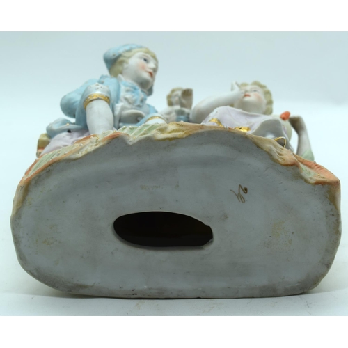 2559 - A large European Bisque figural group depicting cupid and a man and woman.31 x 21cm.