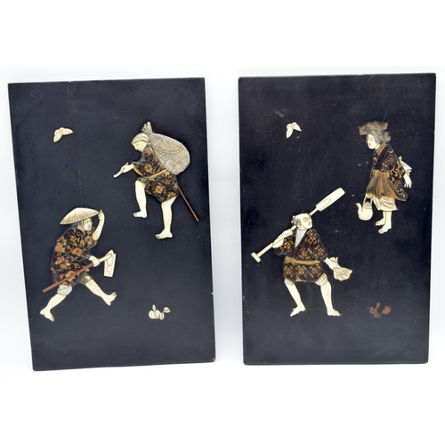 2561 - A pair of Japanese wooden panels decorated with carved Ivory figures 39 x 25cm (2)