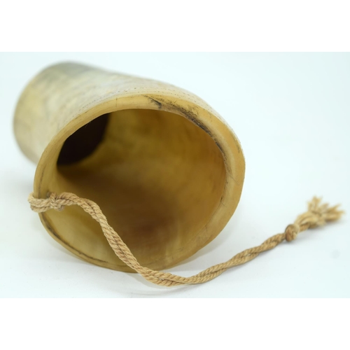 2564 - An engraved horn cup together with a pair of iron oil lamps and a bronze bell sounder. 24cm (4)