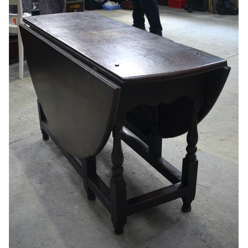 2569 - AN 18TH CENTURY OAK GATELEG DINING TABLE upon cylindrical supports. 118 cm x 70 cm extended.