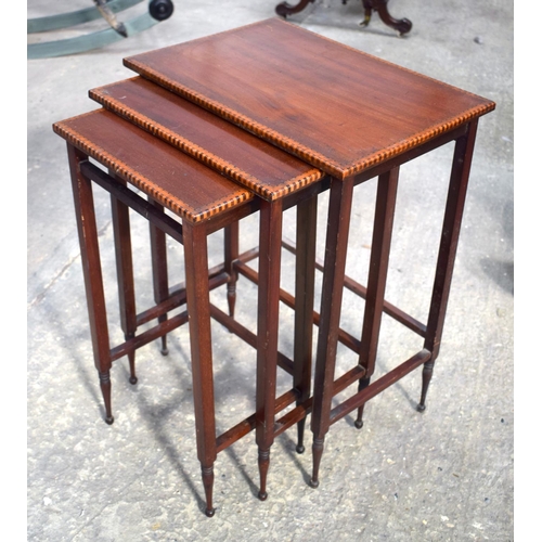 2572 - A NEST OF THREE EDWARDIAN MAHOGANY TABLES. Largest 64 cm x 45 cm.