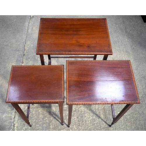 2572 - A NEST OF THREE EDWARDIAN MAHOGANY TABLES. Largest 64 cm x 45 cm.