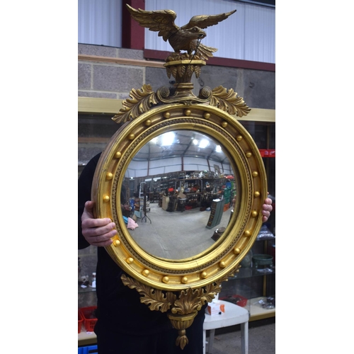 2584 - AN ANTIQUE GILTWOOD EAGLE MIRROR. 109 cm x 60 cm.