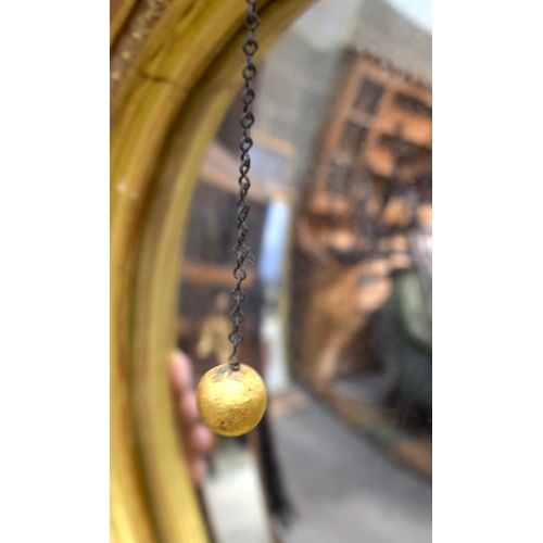 2584 - AN ANTIQUE GILTWOOD EAGLE MIRROR. 109 cm x 60 cm.