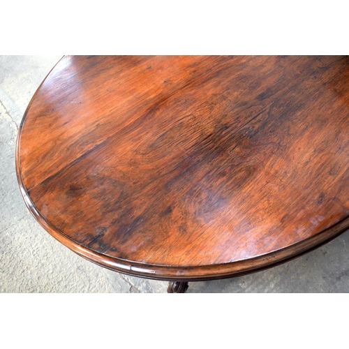 2588 - A LARGE VICTORIAN ROSEWOOD BREAKFAST TABLE upon a scrolling acanthus capped base. 148 cm x 73 cm.