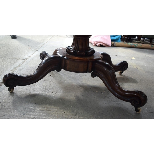 2588 - A LARGE VICTORIAN ROSEWOOD BREAKFAST TABLE upon a scrolling acanthus capped base. 148 cm x 73 cm.