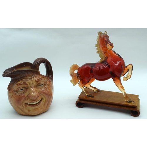 2527 - A  figure of a horse on a stand together with a Character jug of John Barleycorn . 26 x23cm. (2).