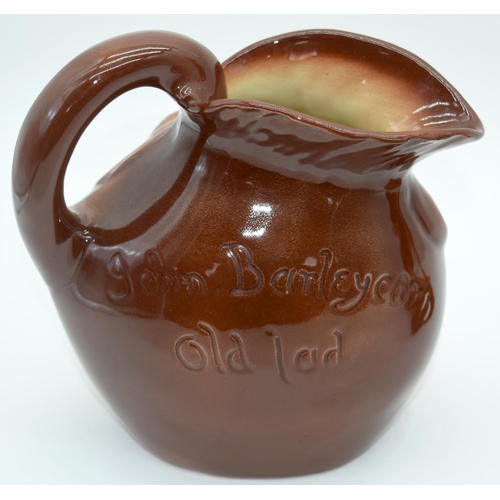 2527 - A  figure of a horse on a stand together with a Character jug of John Barleycorn . 26 x23cm. (2).