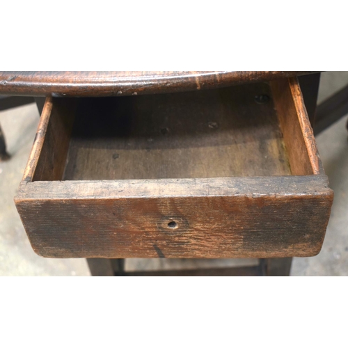 2569 - AN 18TH CENTURY OAK GATELEG DINING TABLE upon cylindrical supports. 118 cm x 70 cm extended.