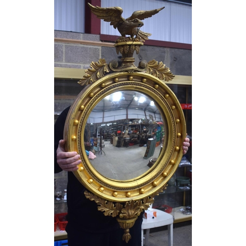 2584 - AN ANTIQUE GILTWOOD EAGLE MIRROR. 109 cm x 60 cm.