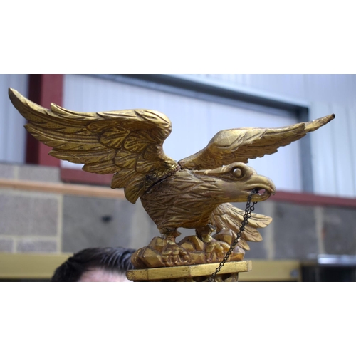 2584 - AN ANTIQUE GILTWOOD EAGLE MIRROR. 109 cm x 60 cm.