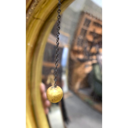 2584 - AN ANTIQUE GILTWOOD EAGLE MIRROR. 109 cm x 60 cm.