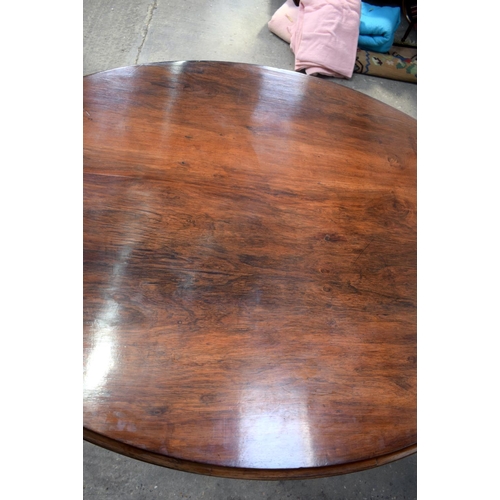 2588 - A LARGE VICTORIAN ROSEWOOD BREAKFAST TABLE upon a scrolling acanthus capped base. 148 cm x 73 cm.