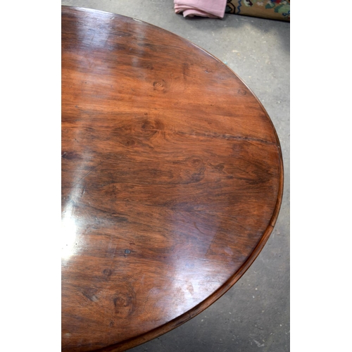 2588 - A LARGE VICTORIAN ROSEWOOD BREAKFAST TABLE upon a scrolling acanthus capped base. 148 cm x 73 cm.