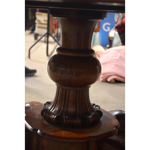 2588 - A LARGE VICTORIAN ROSEWOOD BREAKFAST TABLE upon a scrolling acanthus capped base. 148 cm x 73 cm.