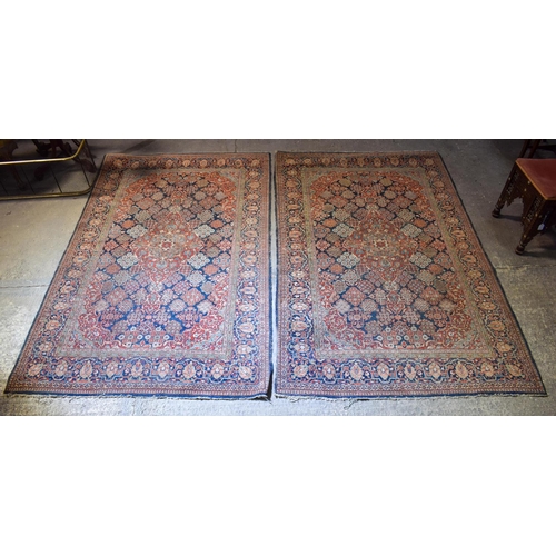 2604 - A LOVELY PAIR OF EARLY 20TH CENTURY MIDDLE EASTERN CARPETS decorated with foliage and vines. 218 cm ... 