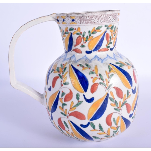 30 - A TURKISH OTTOMAN KUTAHYA FAIENCE TYPE JUG painted with flowers. 16.5 cm high.