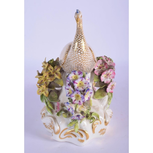 302 - A RARE EARLY 19TH CENTURY DERBY PORCELAIN FIGURE OF A PEACOCK modelled upon an encrusted base. 16 cm... 