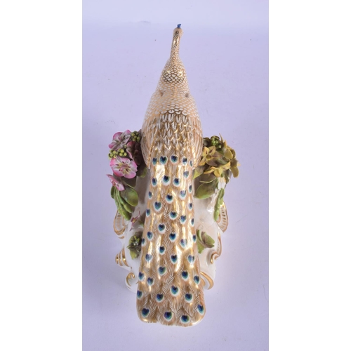 302 - A RARE EARLY 19TH CENTURY DERBY PORCELAIN FIGURE OF A PEACOCK modelled upon an encrusted base. 16 cm... 