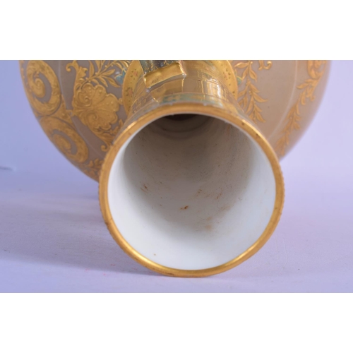 303 - A 19TH CENTURY EUROPEAN TWIN HANDLED PORCELAIN VASE enamelled in relief with gilt flowers. 26 cm x 1... 