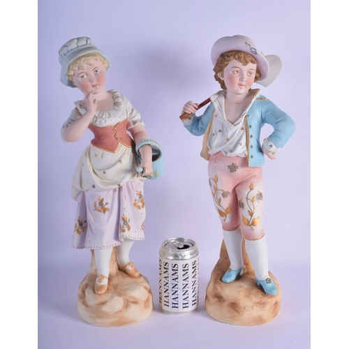 313 - A PAIR OF ANTIQUE BISQUE PORCELAIN FIGURES modelled upon naturalistic bases. 45 cm high.