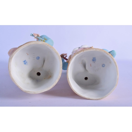 313 - A PAIR OF ANTIQUE BISQUE PORCELAIN FIGURES modelled upon naturalistic bases. 45 cm high.