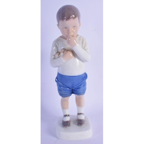 314 - A ROYAL COPENHAGEN PORCELAIN FIGURE OF A BOY modelled eating fruit. 18 cm high.