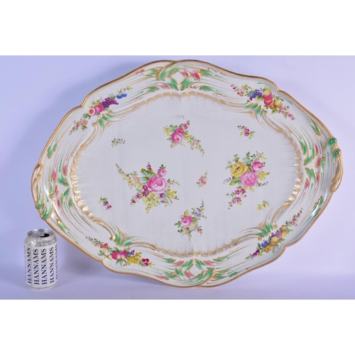 321 - A LARGE ANTIQUE TIN GLAZED POTTERY SERVING TRAY painted with flowers and motifs. 60 cm x 45 cm.