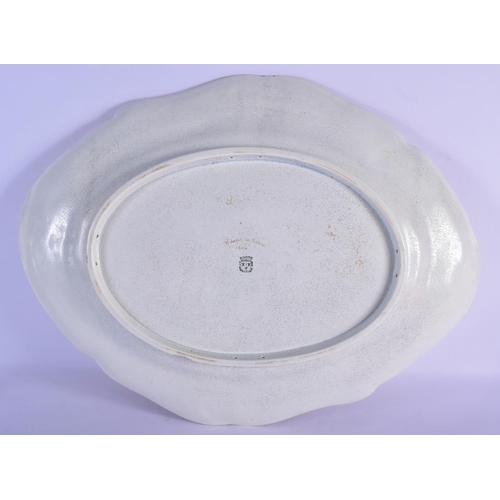 321 - A LARGE ANTIQUE TIN GLAZED POTTERY SERVING TRAY painted with flowers and motifs. 60 cm x 45 cm.