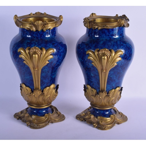 329 - A FINE PAIR OF 19TH CENTURY FRENCH BLUE PORCELAIN VASES overlaid with gilt bronze acanthus mounts. 4... 