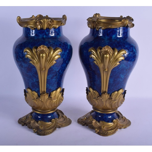 329 - A FINE PAIR OF 19TH CENTURY FRENCH BLUE PORCELAIN VASES overlaid with gilt bronze acanthus mounts. 4... 