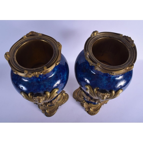 329 - A FINE PAIR OF 19TH CENTURY FRENCH BLUE PORCELAIN VASES overlaid with gilt bronze acanthus mounts. 4... 