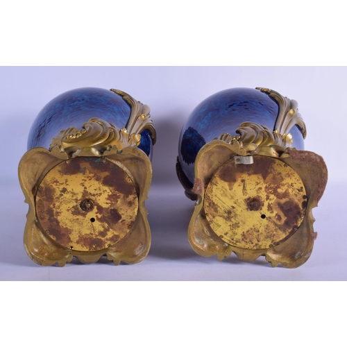 329 - A FINE PAIR OF 19TH CENTURY FRENCH BLUE PORCELAIN VASES overlaid with gilt bronze acanthus mounts. 4... 
