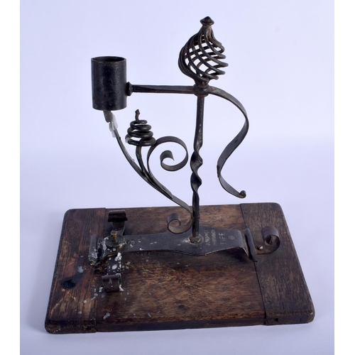 330 - A RARE ANTIQUE SCOTTISH J BENNET OF FIFE WROUGHT IRON RUSHNIP TYPE CANDLE upon a wood plinth. 26 cm ... 