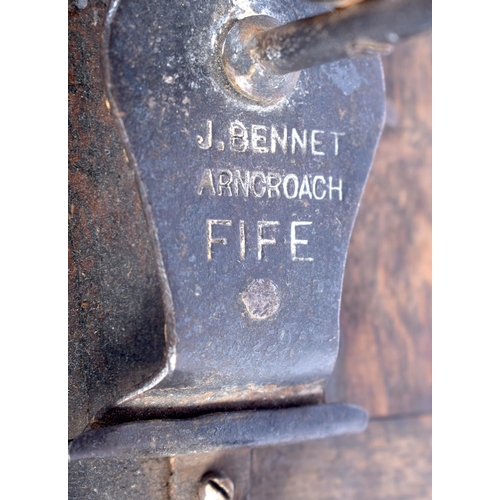 330 - A RARE ANTIQUE SCOTTISH J BENNET OF FIFE WROUGHT IRON RUSHNIP TYPE CANDLE upon a wood plinth. 26 cm ... 