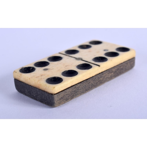 335 - A COLLECTION OF ANTIQUE BONE AND WOOD DOMINOS. (qty)