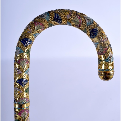 338 - A VINTAGE CONTINENTAL BRASS AND ENAMEL WALKING CANE. 90 cm long.